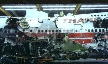 Aircraft wreckage under investigation in a hangar